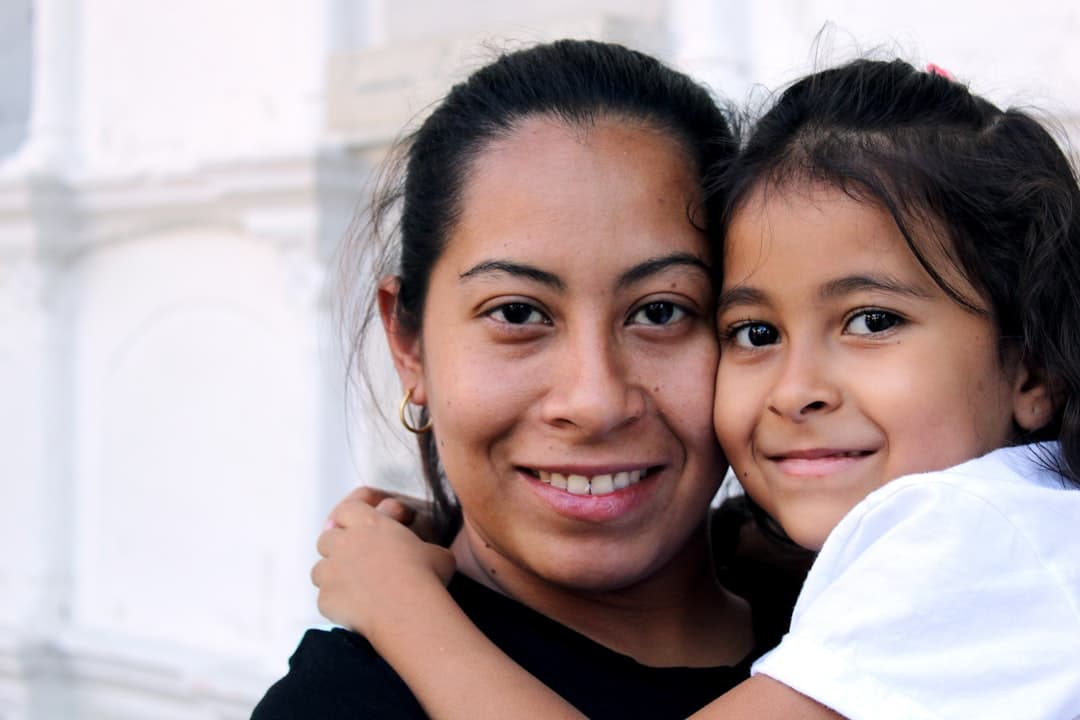 Family with children smiling outside a dental clinic in Calgary